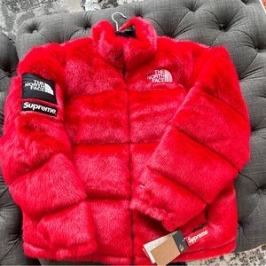 Brand new Supreme x The North Face Faux Fur Nupste jacket in red.